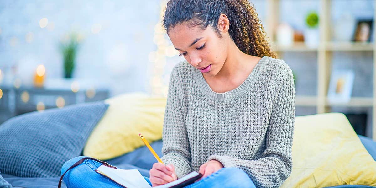 woman writing in a journal