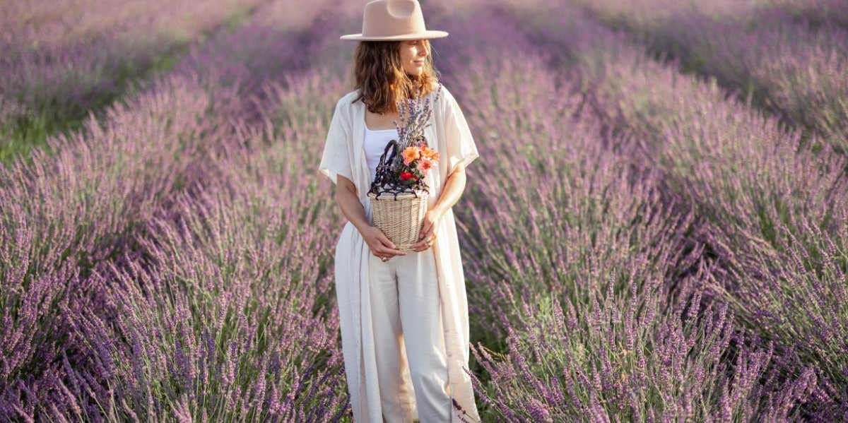 woman holding flowers in a lavender field