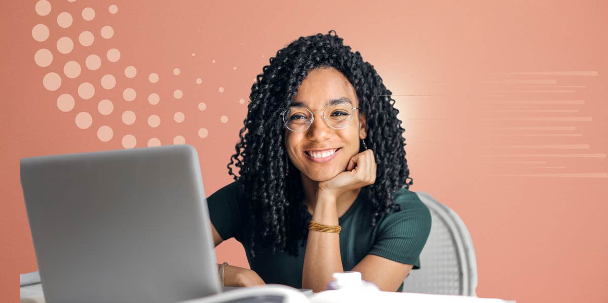 woman happily working at computer