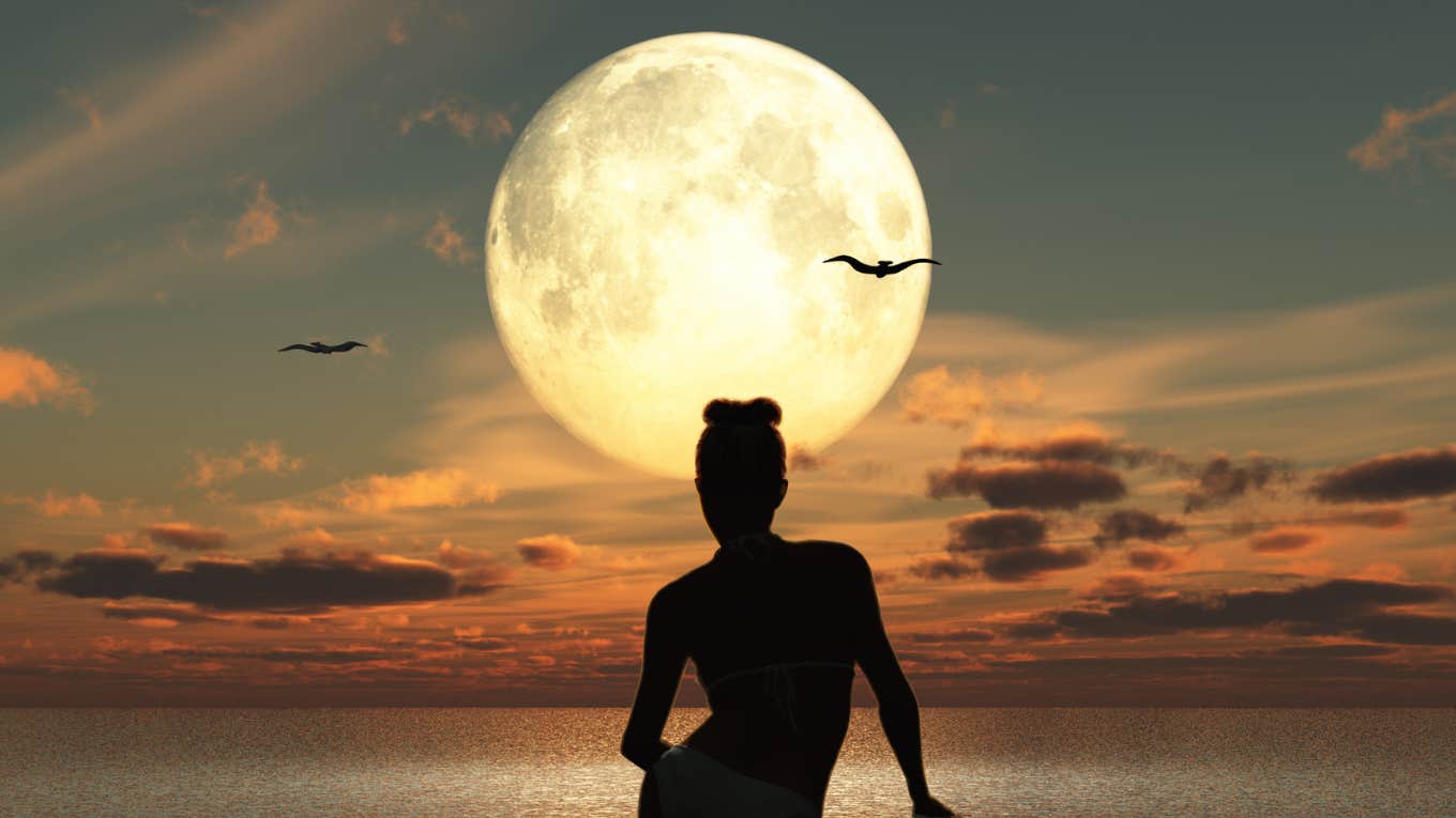 woman sitting by moon