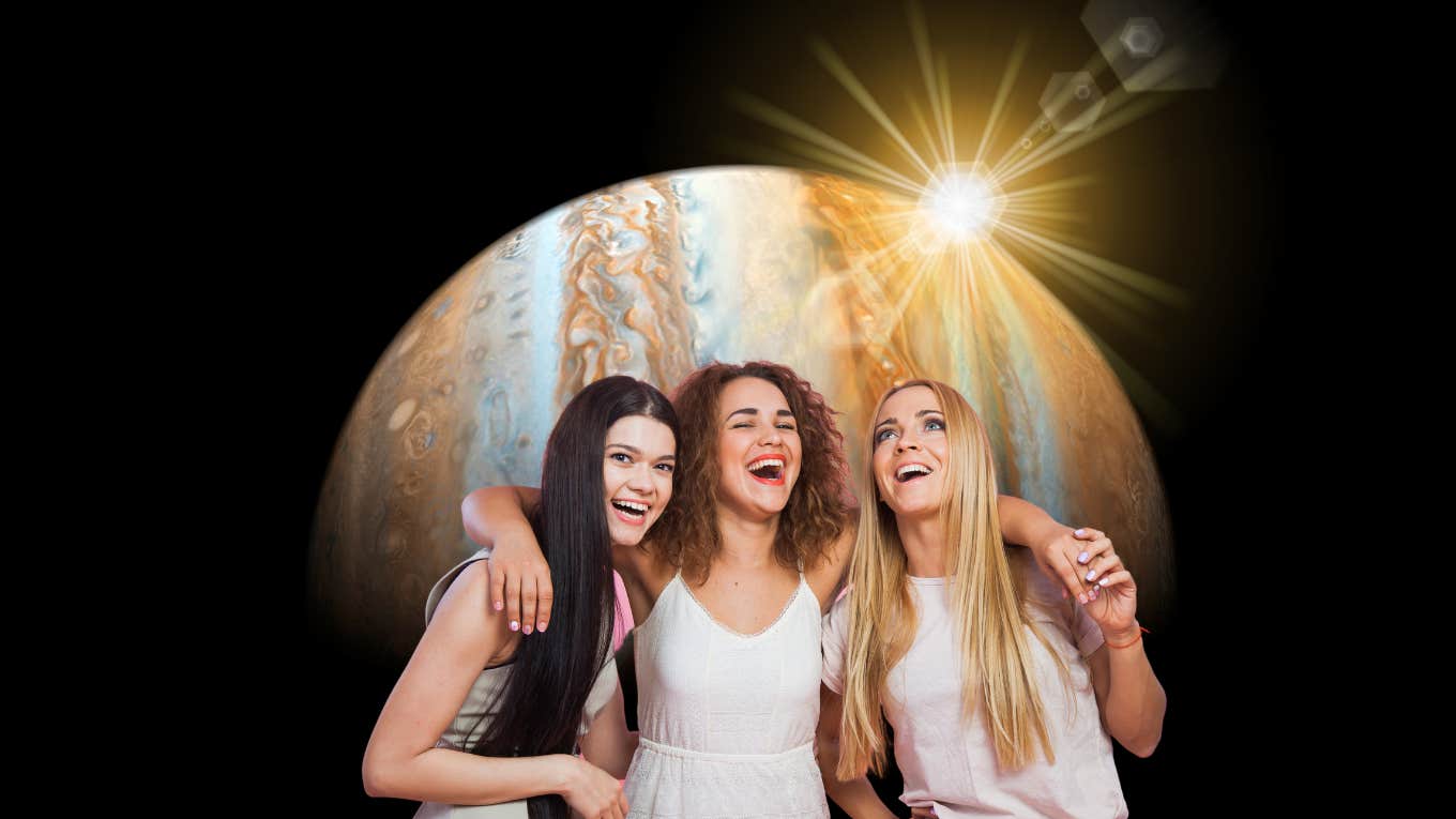 three female friends smiling with jupiter and the sun