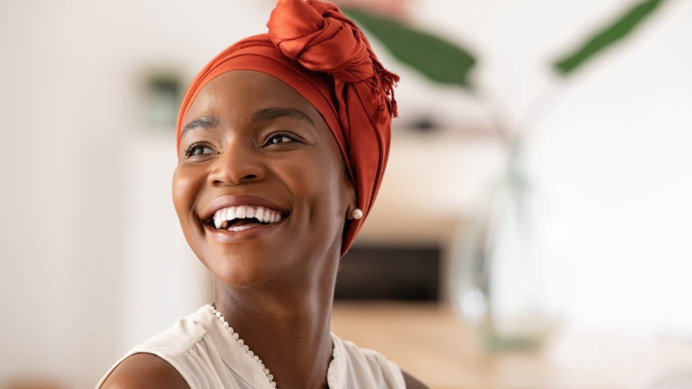 smiling woman with red hair cap