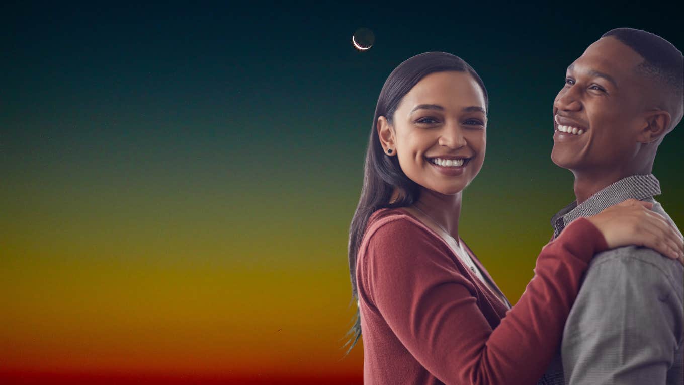 couple smiling beneath a new moon