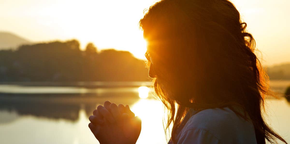 woman praying in nature