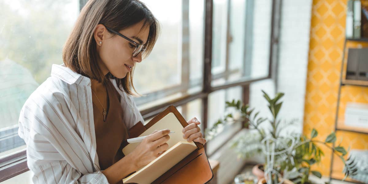 woman writing in a journal