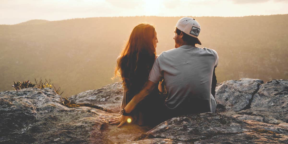 couple sitting on a cliff