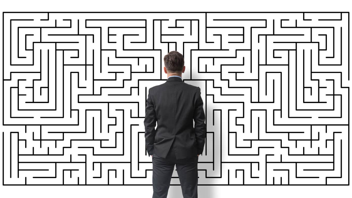 man looking at puzzle