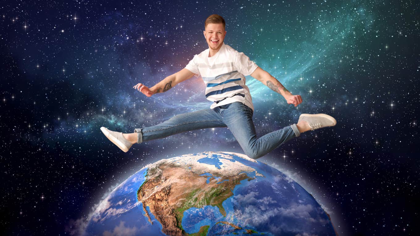 man jumping over planet earth in outerspace