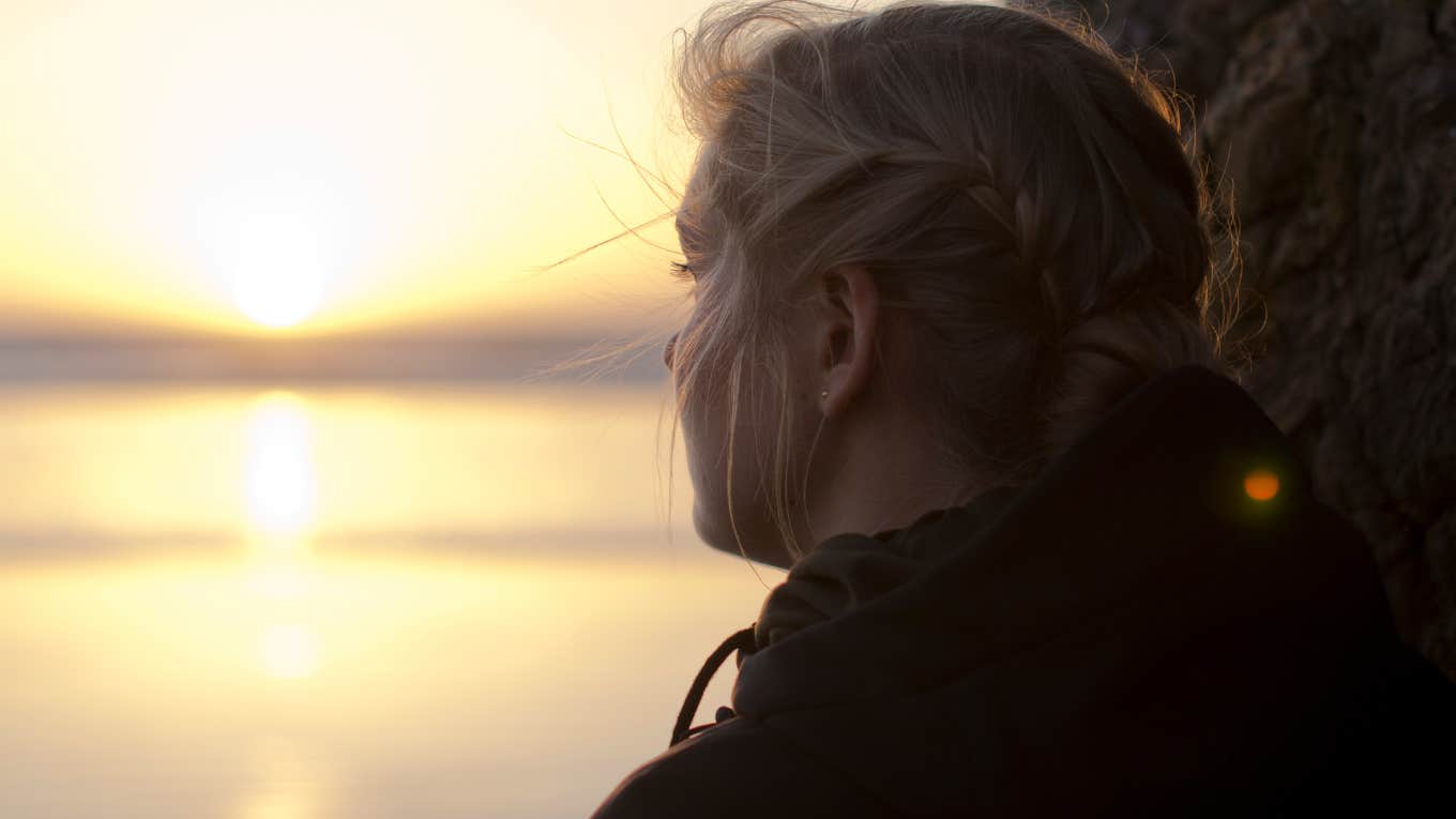 sad woman looking out in water