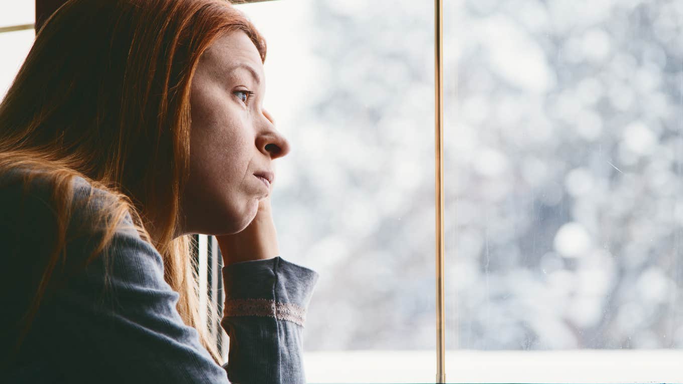 woman looking out window