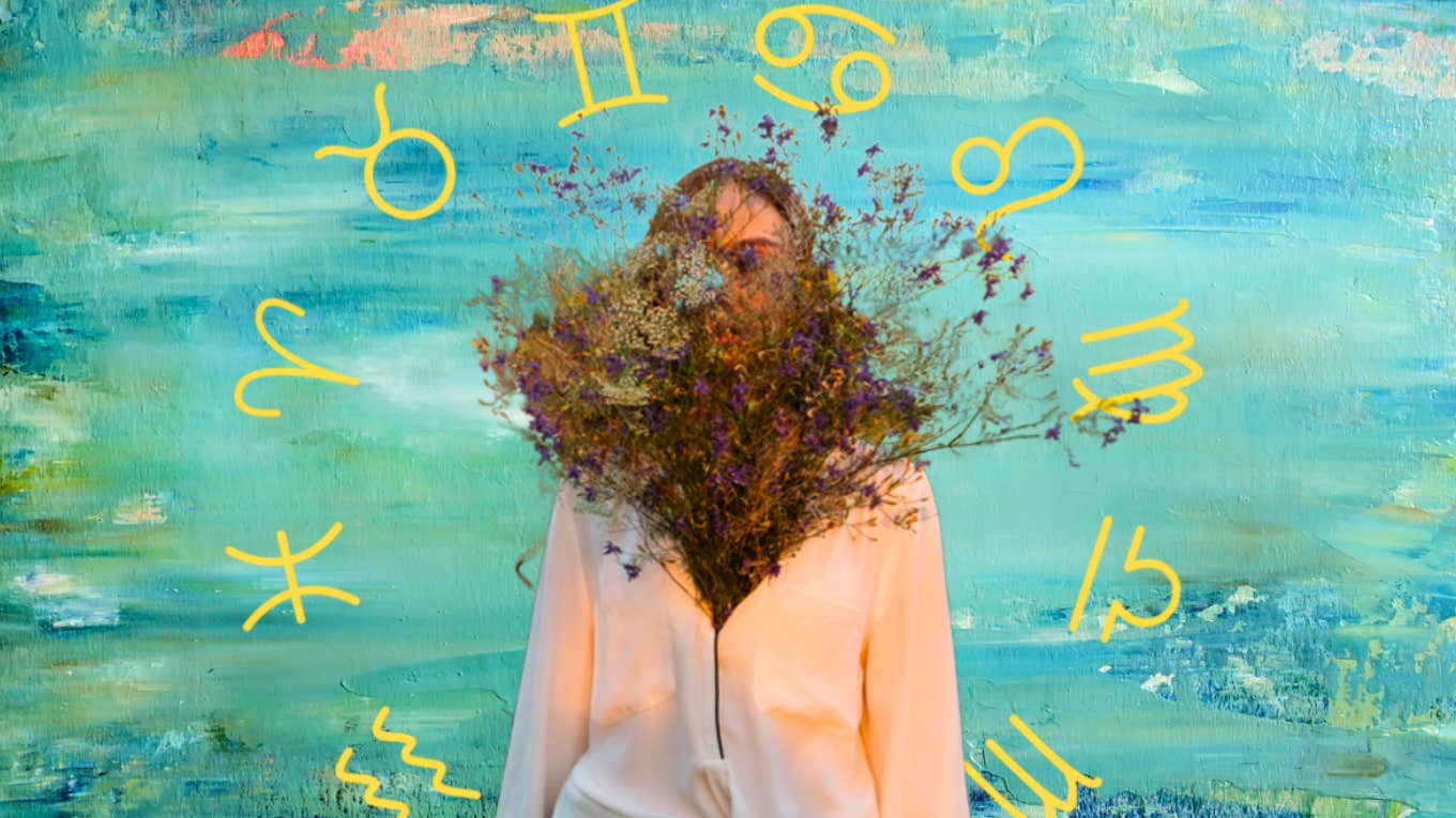 woman hiding behind bouquet of flowers in a sweater