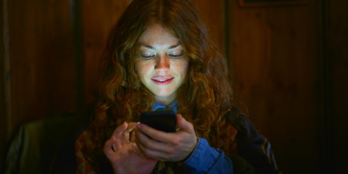 woman typing on smartphone