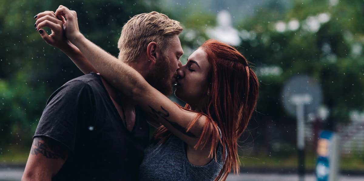 couple kissing in the rain