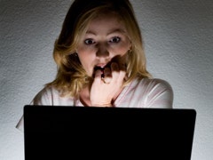 scared woman looking at computer