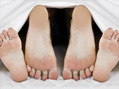 couple's feet in bed