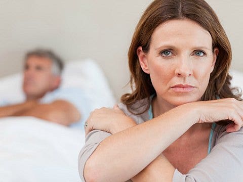 unhappy couple in bed