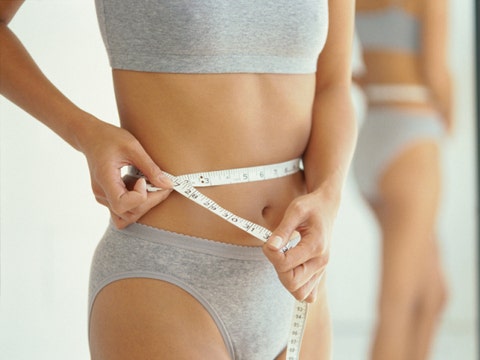 woman measuring waist Do All Women Have Body Image Issues?