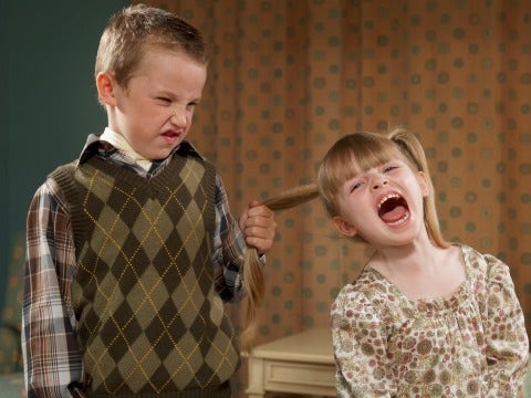 boy pulling girl's hair