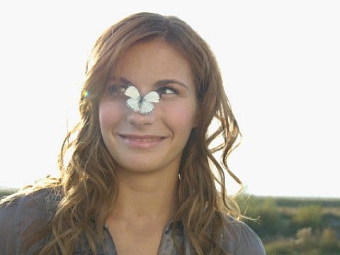 girl with butterfly on nose