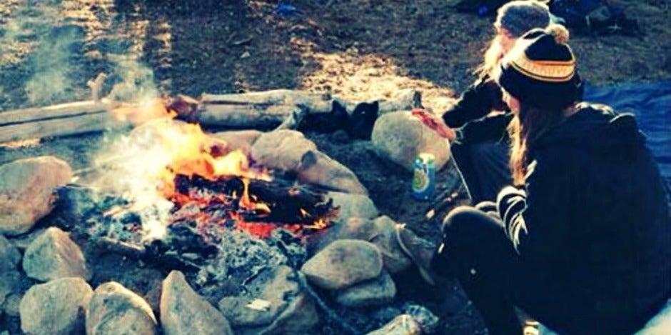couple sitting around campfire