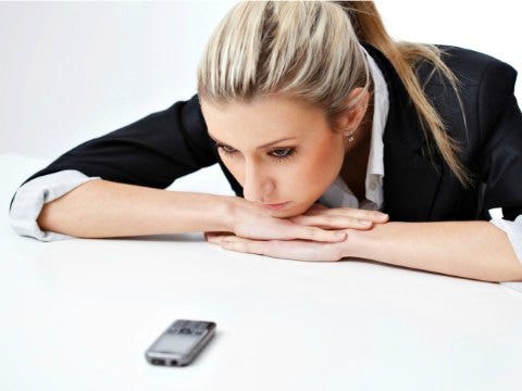 woman staring at phone 