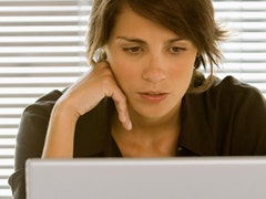 woman on computer woman looking at computer