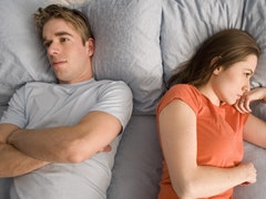 unhappy couple in bed