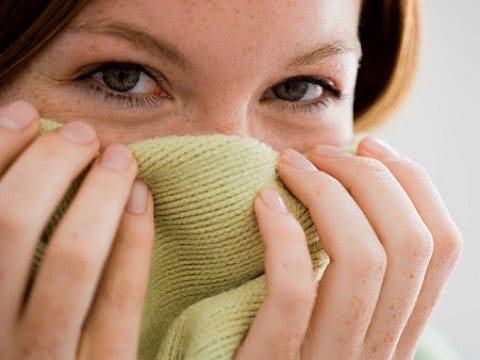 girl hiding behind fabric