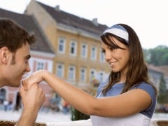 man kissing woman's hand