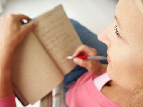 woman making a list in a notebook