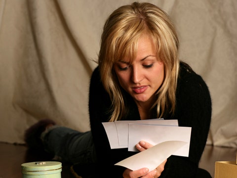 woman looking at photos of ex I Can't Stop Thinking About My Ex!