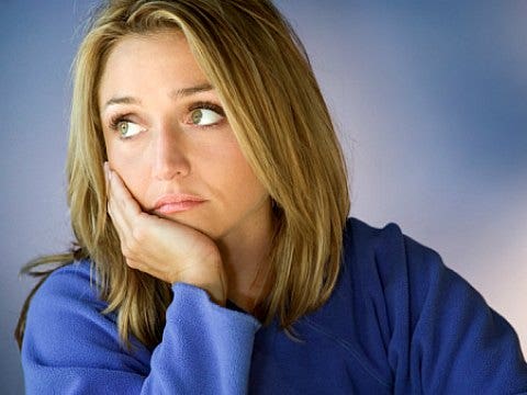 Stressed about money? sad blonde woman wearing blue