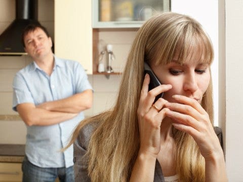 man looking at woman on phone