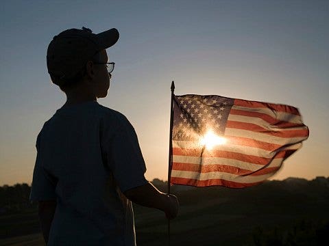 little boy holding a flag