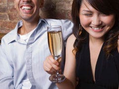 woman and man laughing in a bar