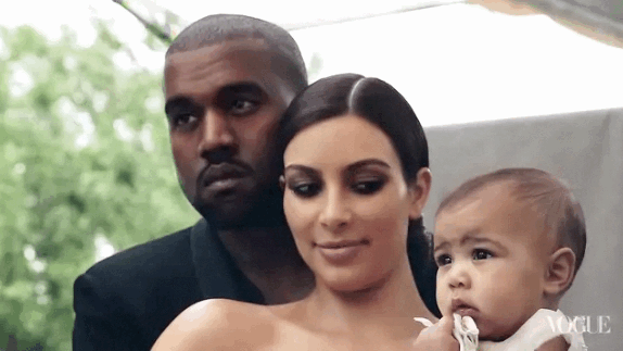 North West just wants to know when these two are going to stop hogging the spotlight Kanye West, Kim Kardashian and North West - Giphy