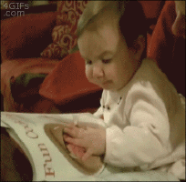 baby eating from a book