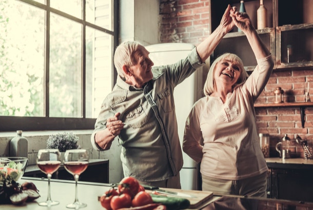 how to live a long life have fun old couple dancing in kitchen