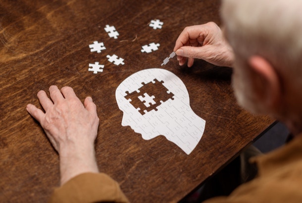 how to live a long life keep your mind active man playing puzzle
