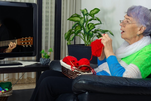 how to live a long life stay single woman watching TV and knitting