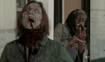 Michonne tied up near a zombie on "The Walking Dead" AMC