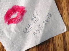 Lipstick and phone number on napkin