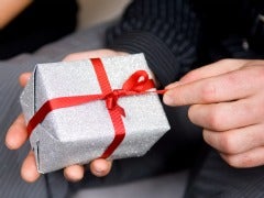 Man's hand opening a Christmas gift