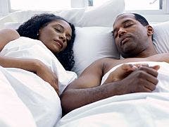 pregnant couple in bed sleeping