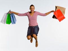 woman jumping with shopping bags