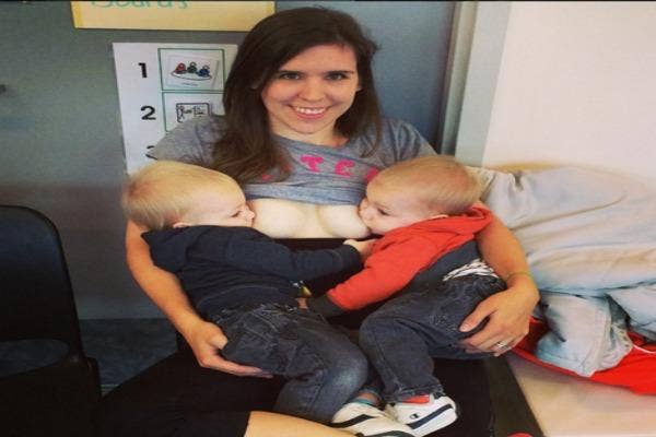 Mom breastfeeding twins.