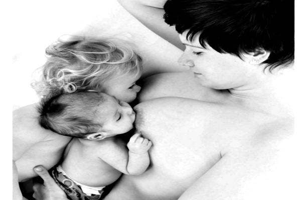 Black and white photo of a mother breastfeeding.