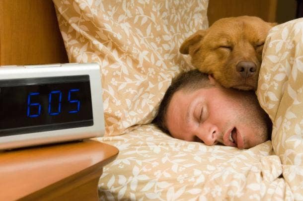 Man sleeping in with dog