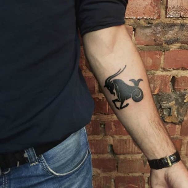 Capricorn Zodiac symbol tattoo on the inner arm.