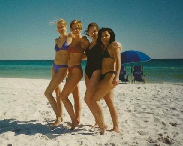 four high school senior girls pose in swimsuits on the beach in Florida, 1996
